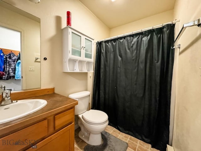 bathroom featuring vanity, curtained shower, tile patterned floors, and toilet