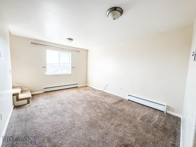 carpeted spare room featuring baseboard heating