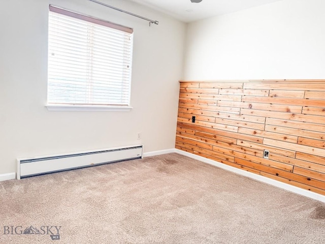 unfurnished room featuring carpet and baseboard heating