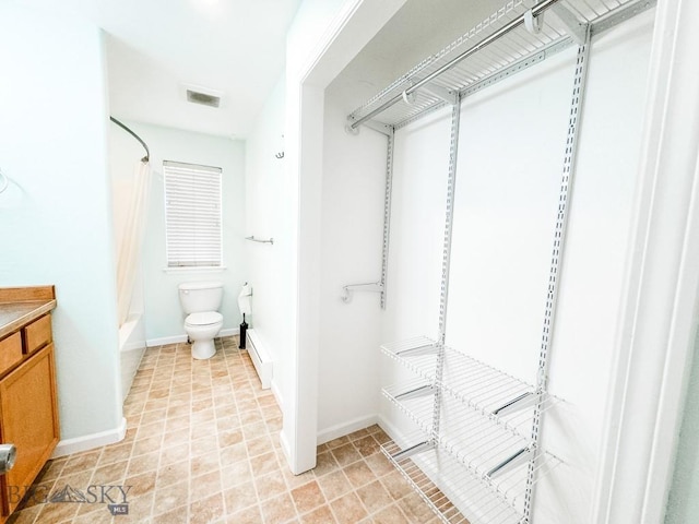 full bathroom featuring vanity, shower / bath combo with shower curtain, and toilet