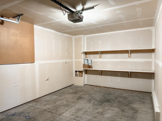 garage featuring a baseboard heating unit and a garage door opener