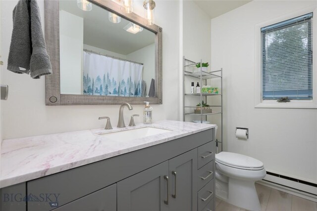 bathroom featuring vanity, a baseboard radiator, and toilet