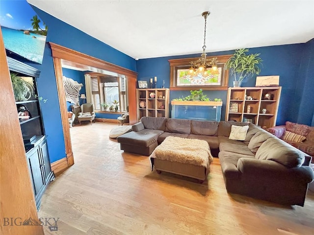 living room featuring light hardwood / wood-style flooring and a chandelier