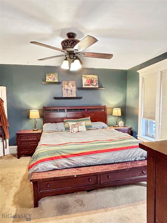 carpeted bedroom with ceiling fan