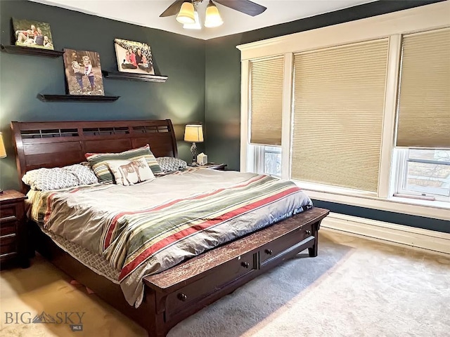 bedroom with carpet flooring, multiple windows, and ceiling fan