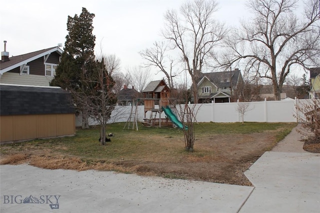 view of jungle gym featuring a lawn and a storage shed