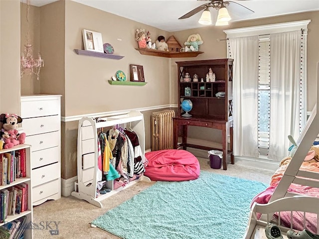 bedroom featuring carpet, ceiling fan, and radiator