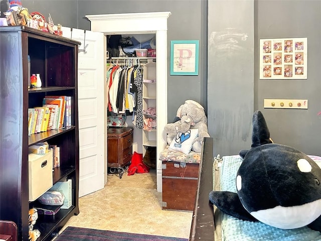 bedroom with light carpet and a closet