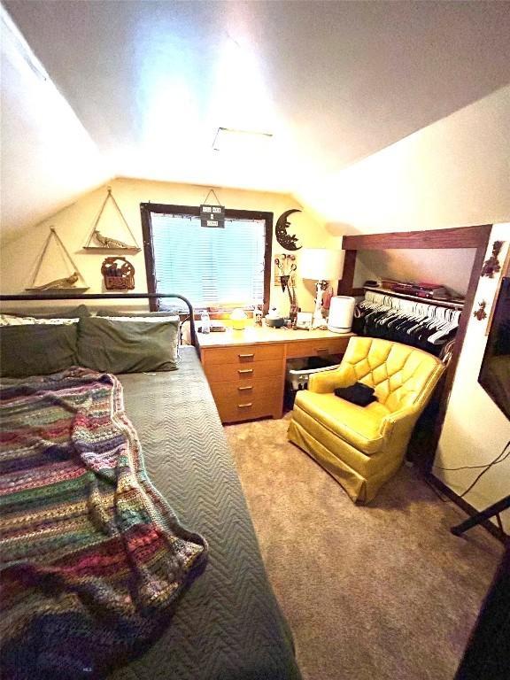 bedroom with carpet and vaulted ceiling