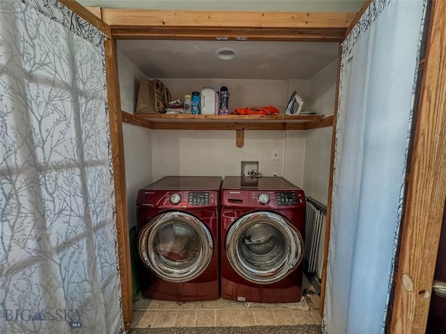 laundry room with washing machine and dryer and light tile patterned flooring