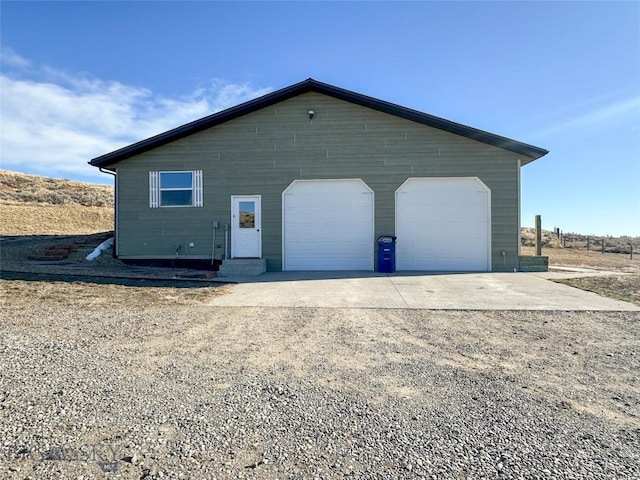 view of front of home featuring a garage and an outdoor structure