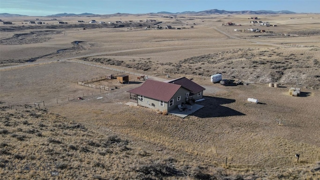 birds eye view of property featuring a mountain view and a rural view