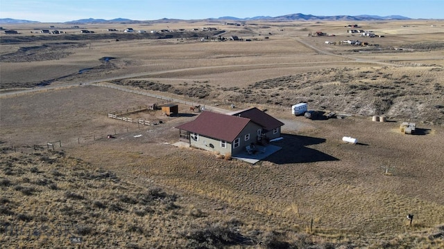 birds eye view of property with a mountain view and a rural view