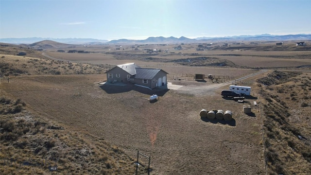 drone / aerial view featuring a mountain view and a rural view