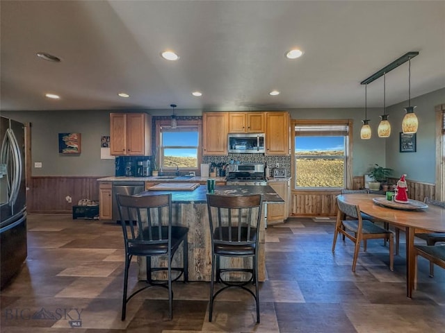 kitchen with decorative light fixtures, stainless steel appliances, a healthy amount of sunlight, and sink