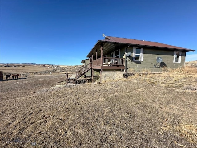 view of property exterior featuring a wooden deck