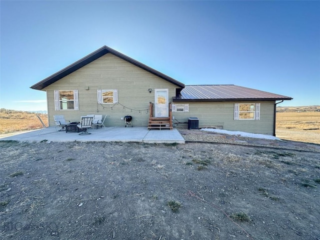 back of house featuring central air condition unit and a patio