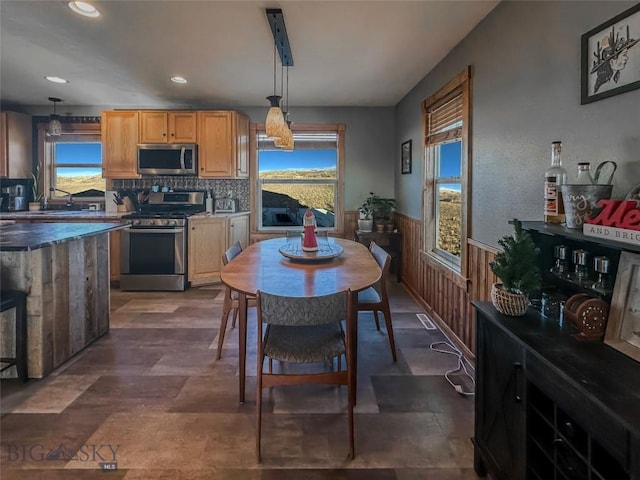 dining room featuring wood walls