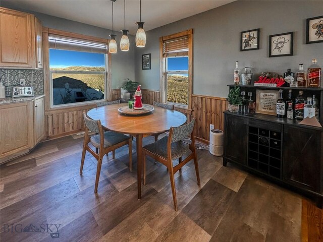 dining room with wooden walls