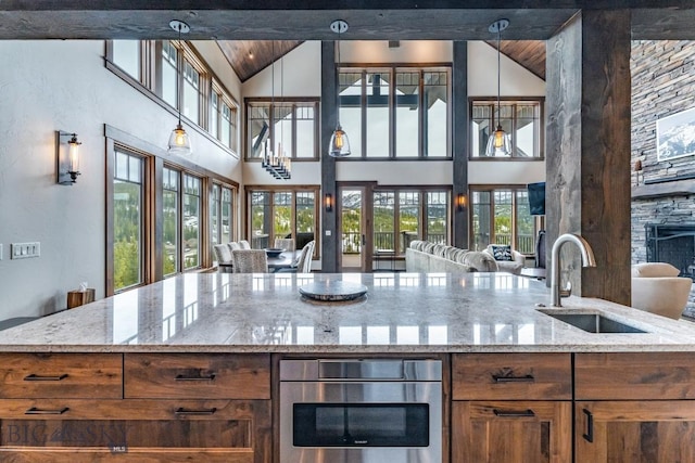 kitchen with decorative light fixtures, plenty of natural light, and sink