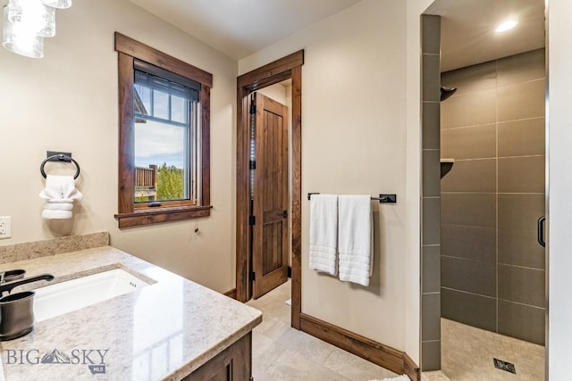 bathroom with tile patterned floors, vanity, and a shower with shower door