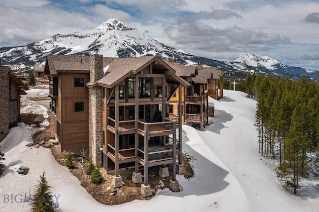 snow covered house with a mountain view