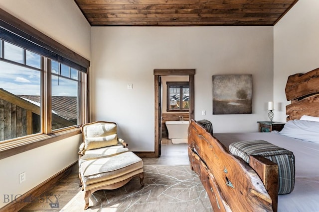 bedroom featuring wood-type flooring, ensuite bath, and wooden ceiling