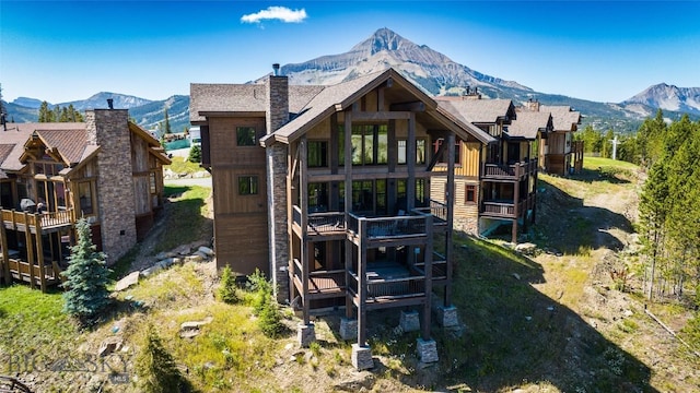 back of house featuring a deck with mountain view