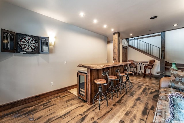 bar with hardwood / wood-style floors and beverage cooler