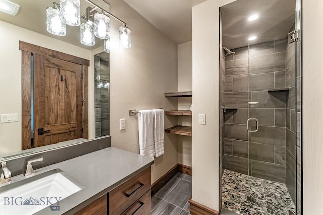 bathroom featuring vanity and a shower with shower door