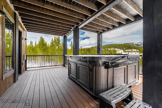 wooden deck with a hot tub