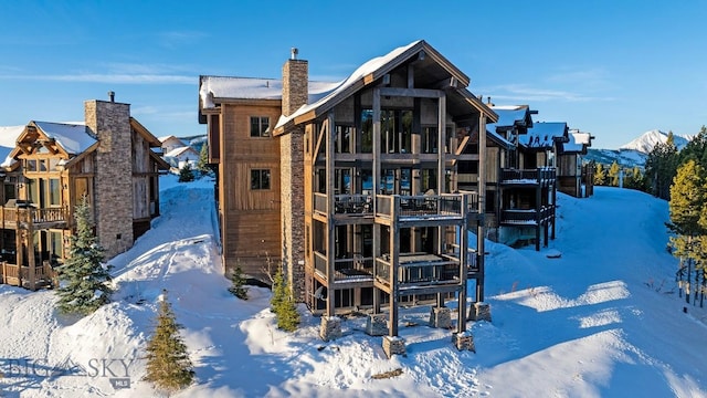 snow covered house with a mountain view