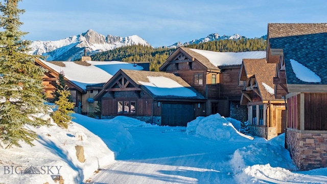 snowy aerial view with a mountain view