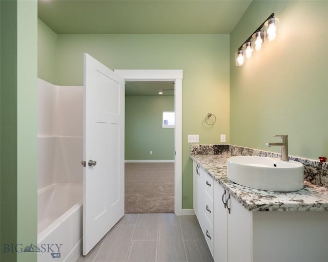 bathroom featuring baseboards and vanity