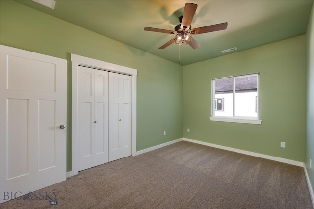 unfurnished bedroom featuring a closet, carpet, visible vents, and baseboards