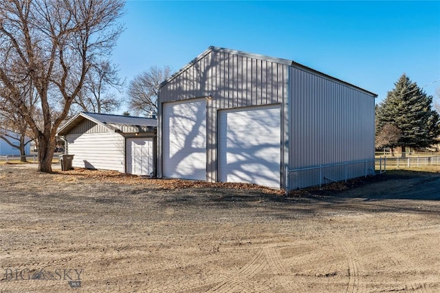 detached garage with dirt driveway