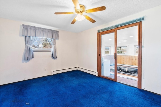 empty room with ceiling fan, dark carpet, baseboard heating, and a textured ceiling