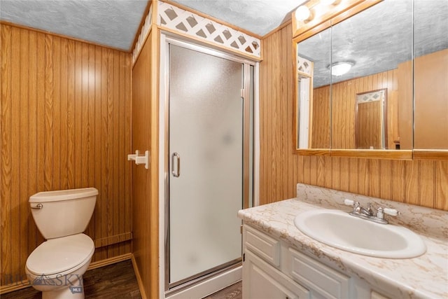 full bathroom with toilet, a stall shower, a textured ceiling, and wood walls