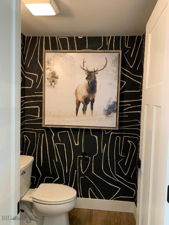 bathroom featuring hardwood / wood-style floors and toilet