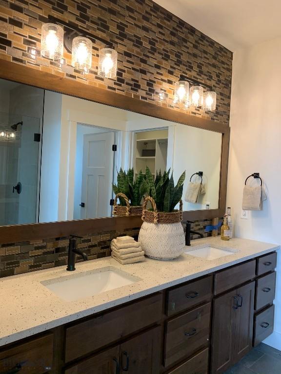 bathroom with vanity, tasteful backsplash, and walk in shower