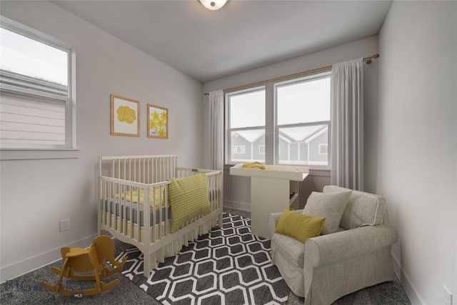 carpeted bedroom with a nursery area