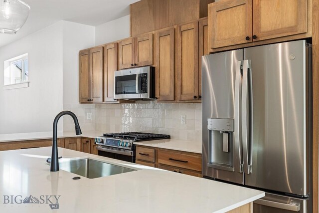 kitchen with stainless steel appliances, tasteful backsplash, and sink