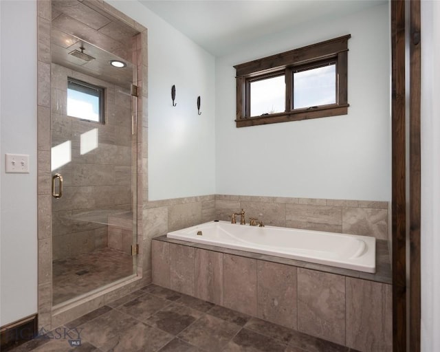 bathroom with tile patterned floors and shower with separate bathtub