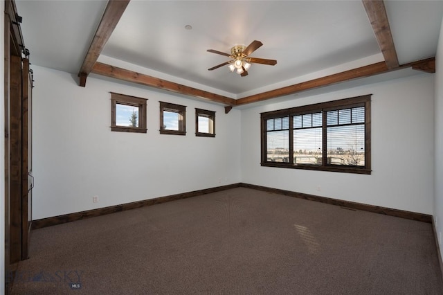 carpeted spare room featuring beam ceiling, a barn door, and ceiling fan