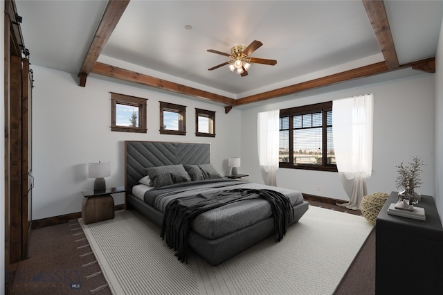 carpeted bedroom with beamed ceiling and ceiling fan