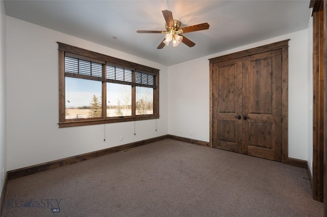 unfurnished bedroom featuring carpet and ceiling fan