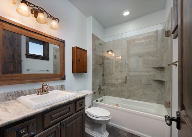 full bathroom featuring vanity, toilet, and bath / shower combo with glass door