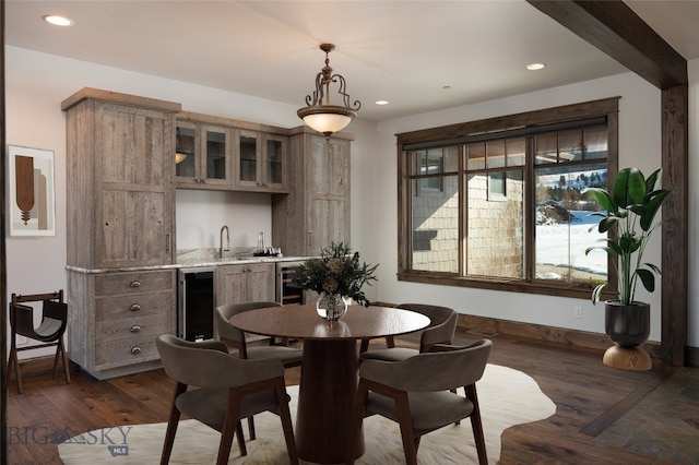 dining room with dark hardwood / wood-style floors, indoor wet bar, and wine cooler