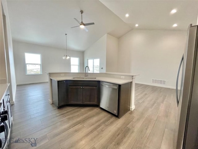 kitchen with a wealth of natural light, sink, lofted ceiling, and appliances with stainless steel finishes