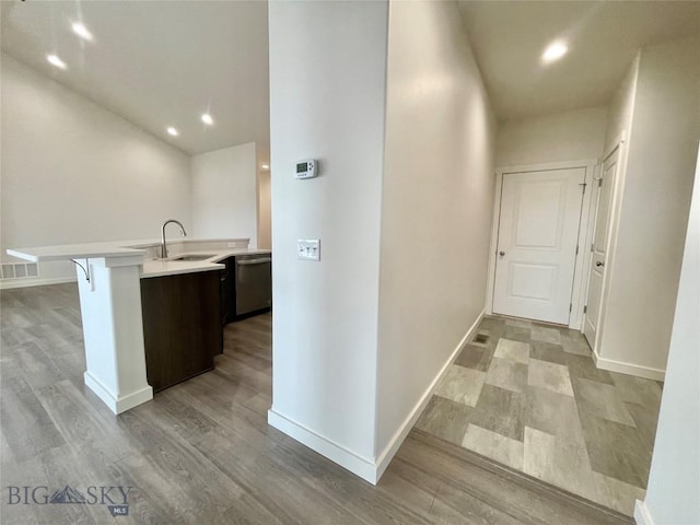 hallway featuring sink and light hardwood / wood-style floors